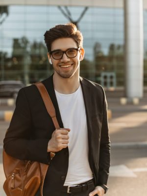 happy-businessman-in-eyeglasses-looks-into-camera-and-smiles-sincerely-brunette-guy-in-black-jacke.jpg